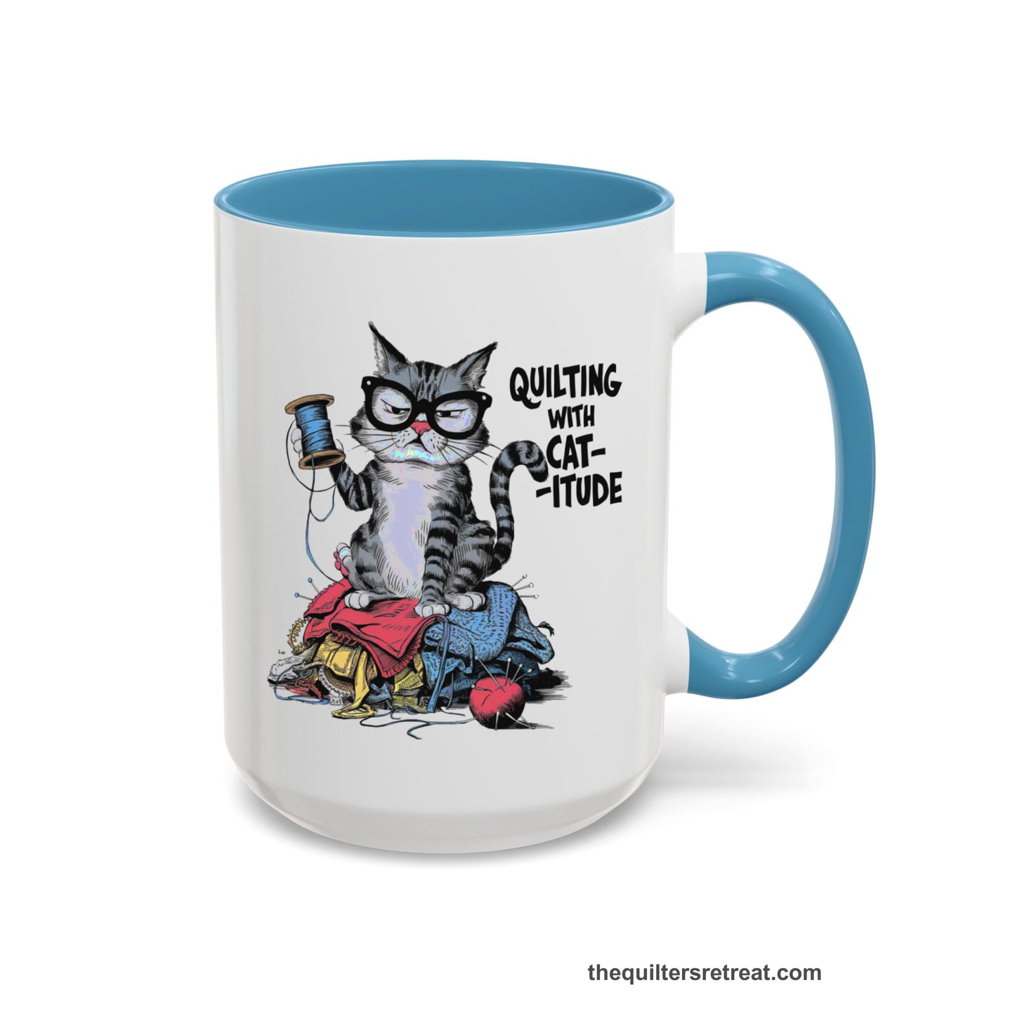 A Light Blue Accent Ceramic Mug featuring Quilting with Catitude design with a grumpy cat holding thread spool atop fabric pile