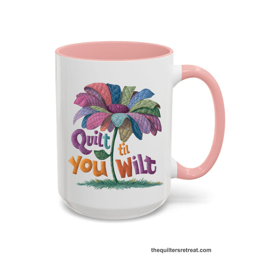 A Pink Self-Fulfilled Accent Mug with a whimsical quilted flower with bold "Quilt til You Wilt" text