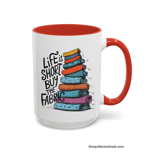 A Self-Fulfilled Accent Mug with a illustration of colorful fabric rolls with bold "Life is Short Buy the Fabric" text