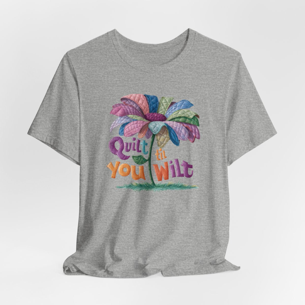 An Athletic Heather funny quilting T-Shirt with the phrase Quilt 'Till You Wilt showing a cheerful, but slightly wilted quilted flower design