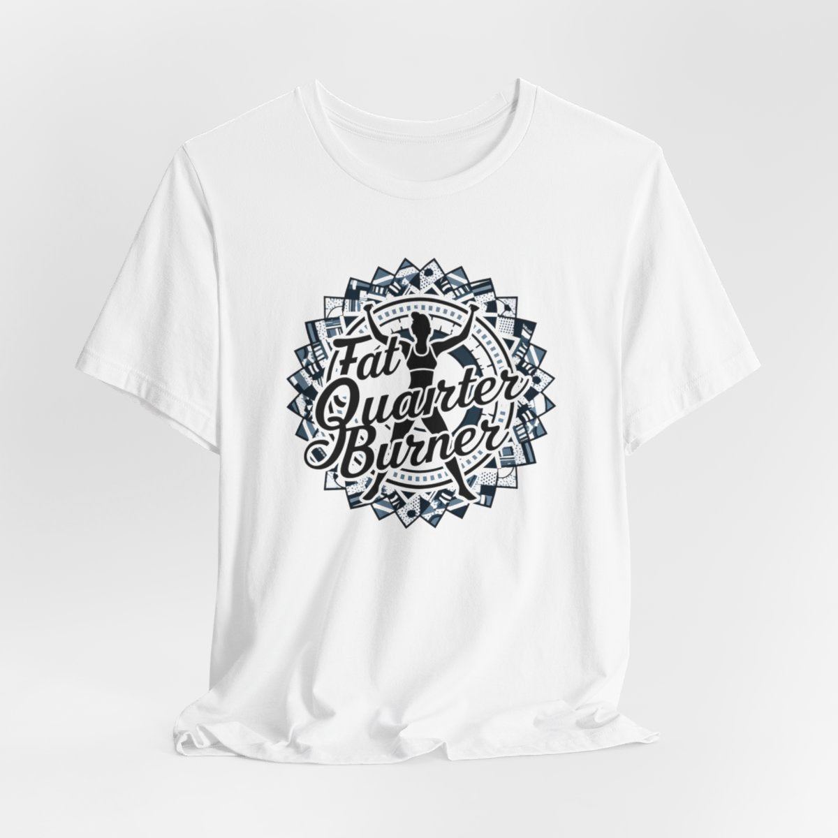 A White T-Shirt featuring a patchwork border surrounding silhouette of woman lifting weights. Text reads "Fat Quarter Burner" in bold script.