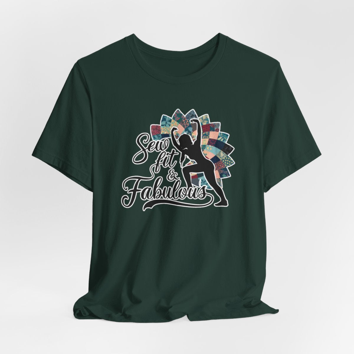 A Forest T-Shirt featuring a black silhouette of woman with raised arms against colorful patchwork background. Text reads "Sew fit & Fabulous" in stylized script.