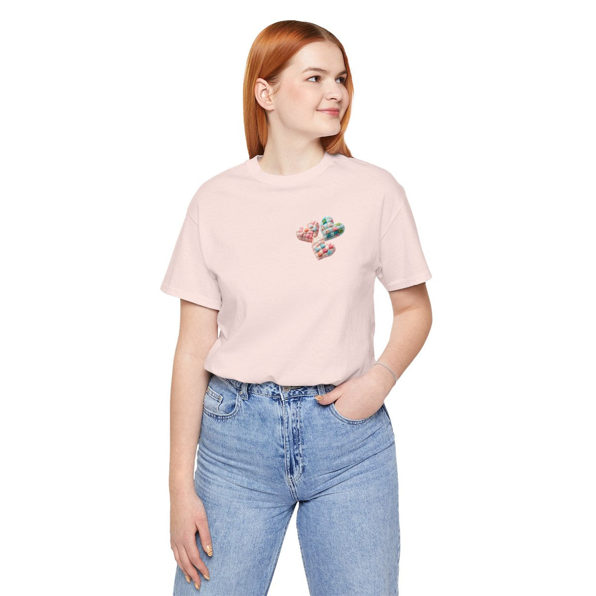 A Soft Pink Tshirt featuring Three heart-shaped quilted designs arranged together. Each heart features different quilting patterns and textures, including patchwork, floral prints, and tiny embroidered hearts. The hearts are in pastel shades of pink and blue, with white accents.