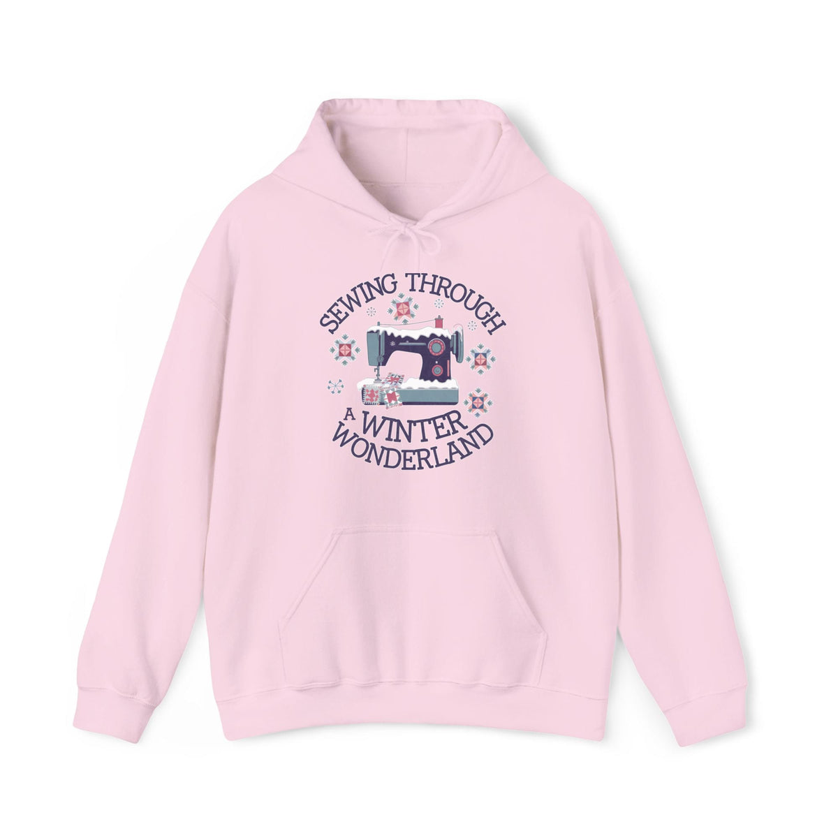 Quilter Gift: A Light Pink Hoodie with sewing machine covered in snow with festive quilting elements and "Sewing Through a Winter Wonderland" text