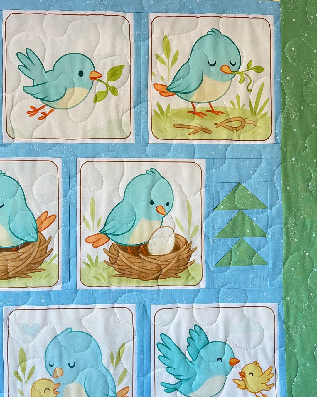 Close-up of the Little Birdie panel's bluebird and nest blocks