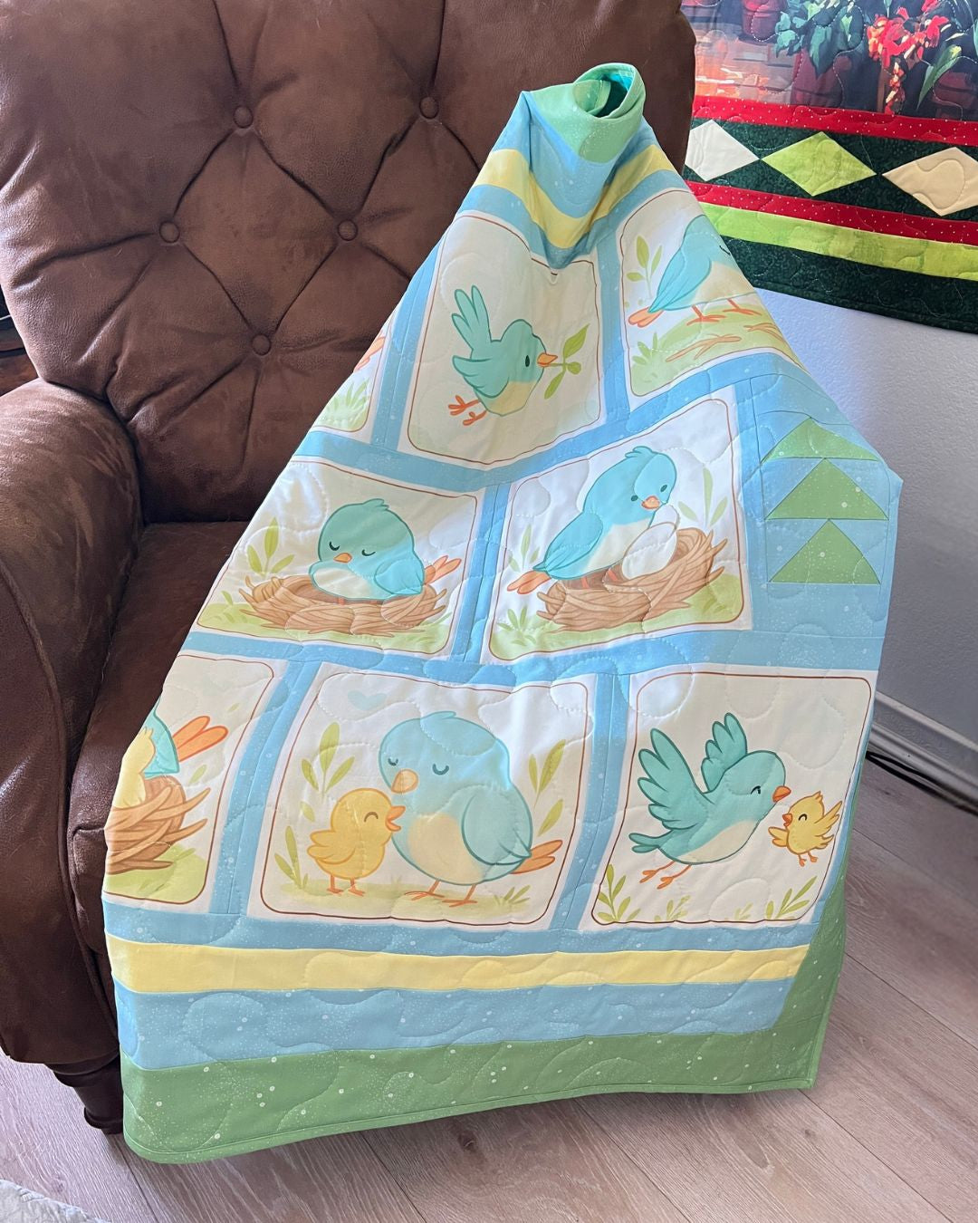 Little Birdie bluebird quilt folded over a chair