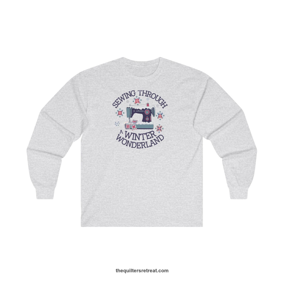 Quilter Gift: A Ash Long Sleeve T-Shirt with sewing machine covered in snow with festive quilting elements and 'Sewing Through a Winter Wonderland' text