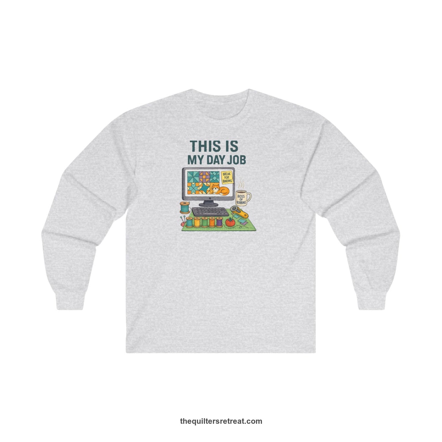 A Ash Long Sleeve T-Shirt with a computer quilt design, cat illustration, "THIS IS MY DAY JOB" text with sewing tools, playful style