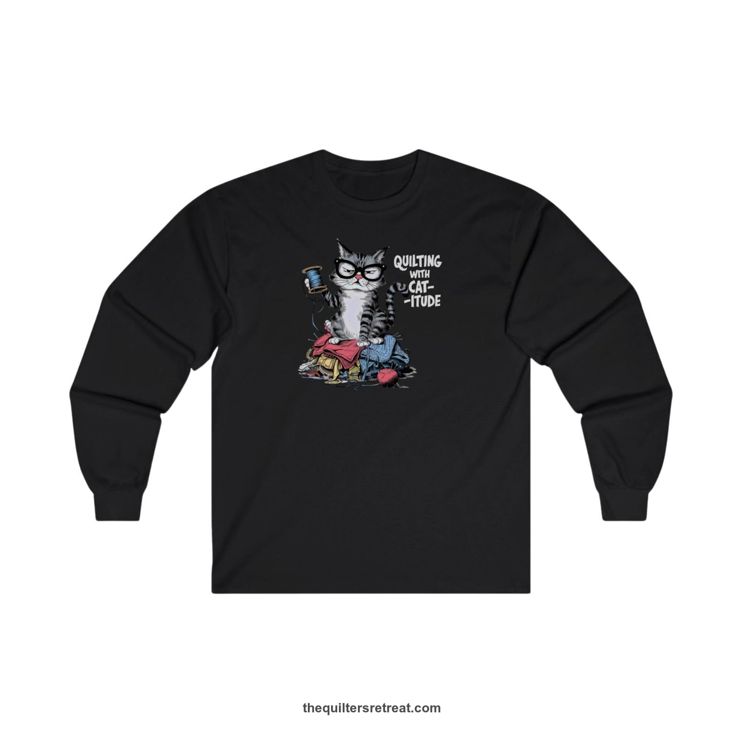 A Black Long Sleeve T-Shirt with a grumpy cat holding thread spool atop fabric pile with "Quilting with Cat-itude" text