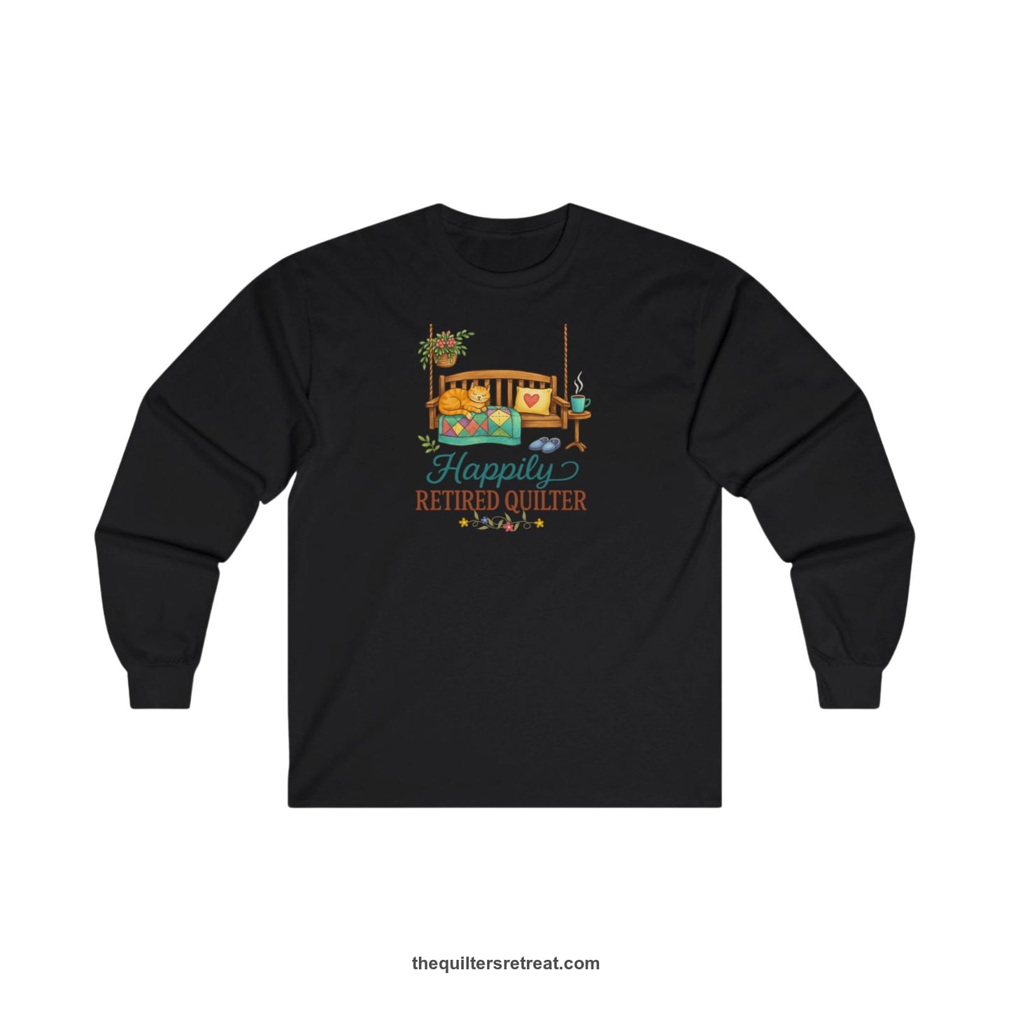 A Black Long Sleeve T-Shirt with a hanging bench with cozy cat and quilt, surrounded by plants, "Happily Retired Quilter" text