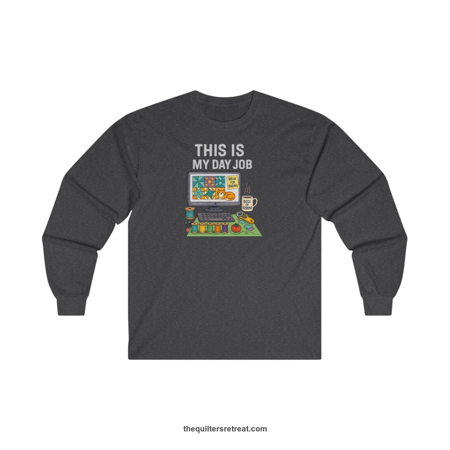 A Dark Heather Long Sleeve T-Shirt with a computer quilt design, cat illustration, "THIS IS MY DAY JOB" text with sewing tools, playful style