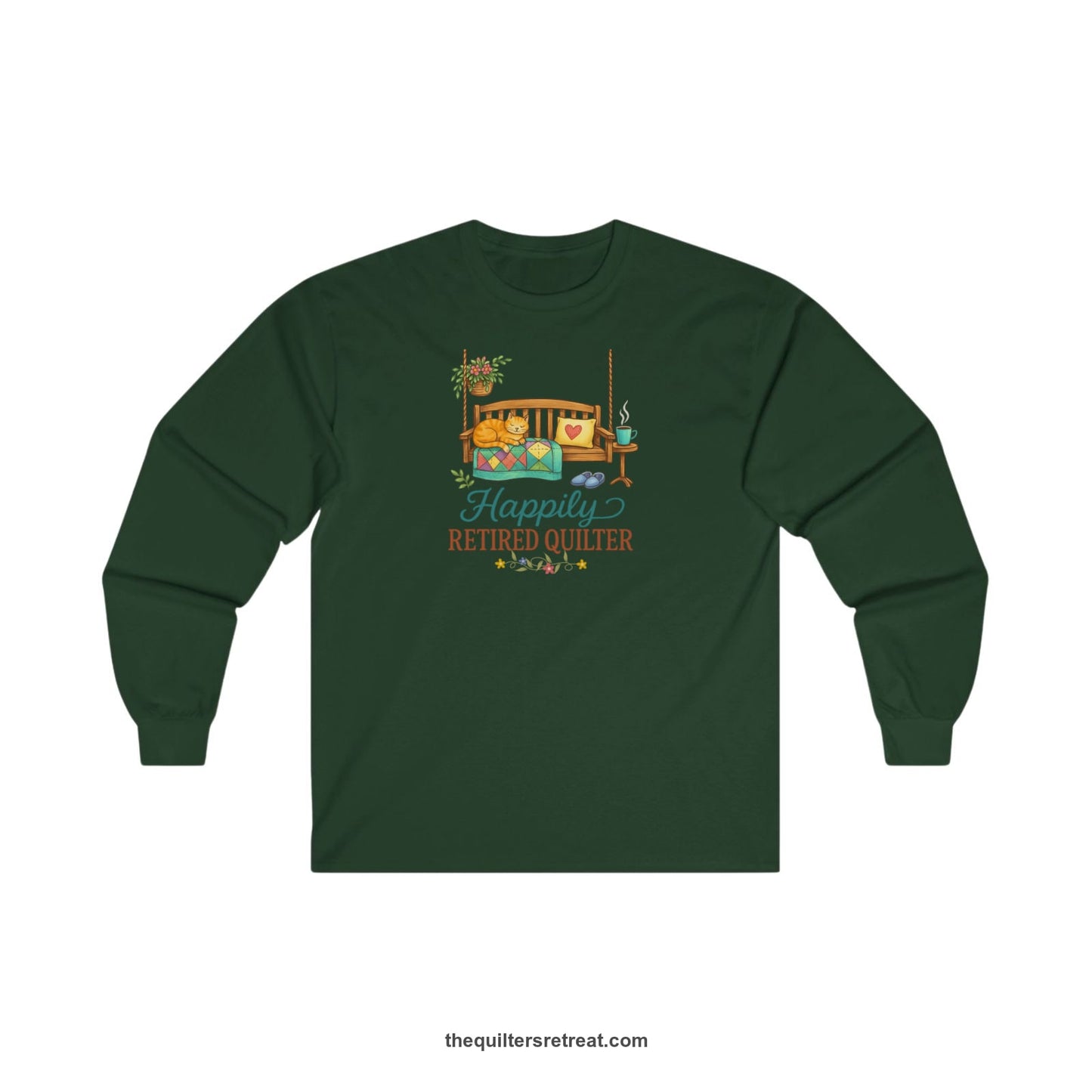 A Forest Green Long Sleeve T-Shirt with a hanging bench with cozy cat and quilt, surrounded by plants, "Happily Retired Quilter" text