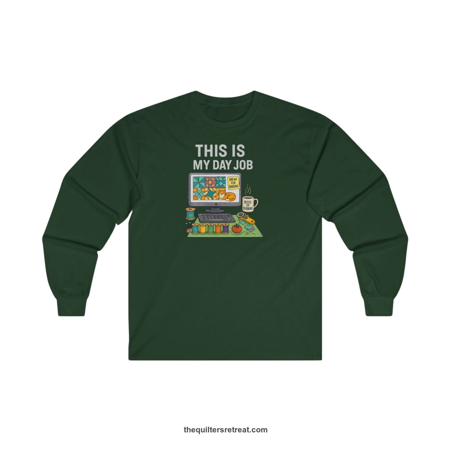 A Forest Green Long Sleeve T-Shirt with a computer quilt design, cat illustration, "THIS IS MY DAY JOB" text with sewing tools, playful style
