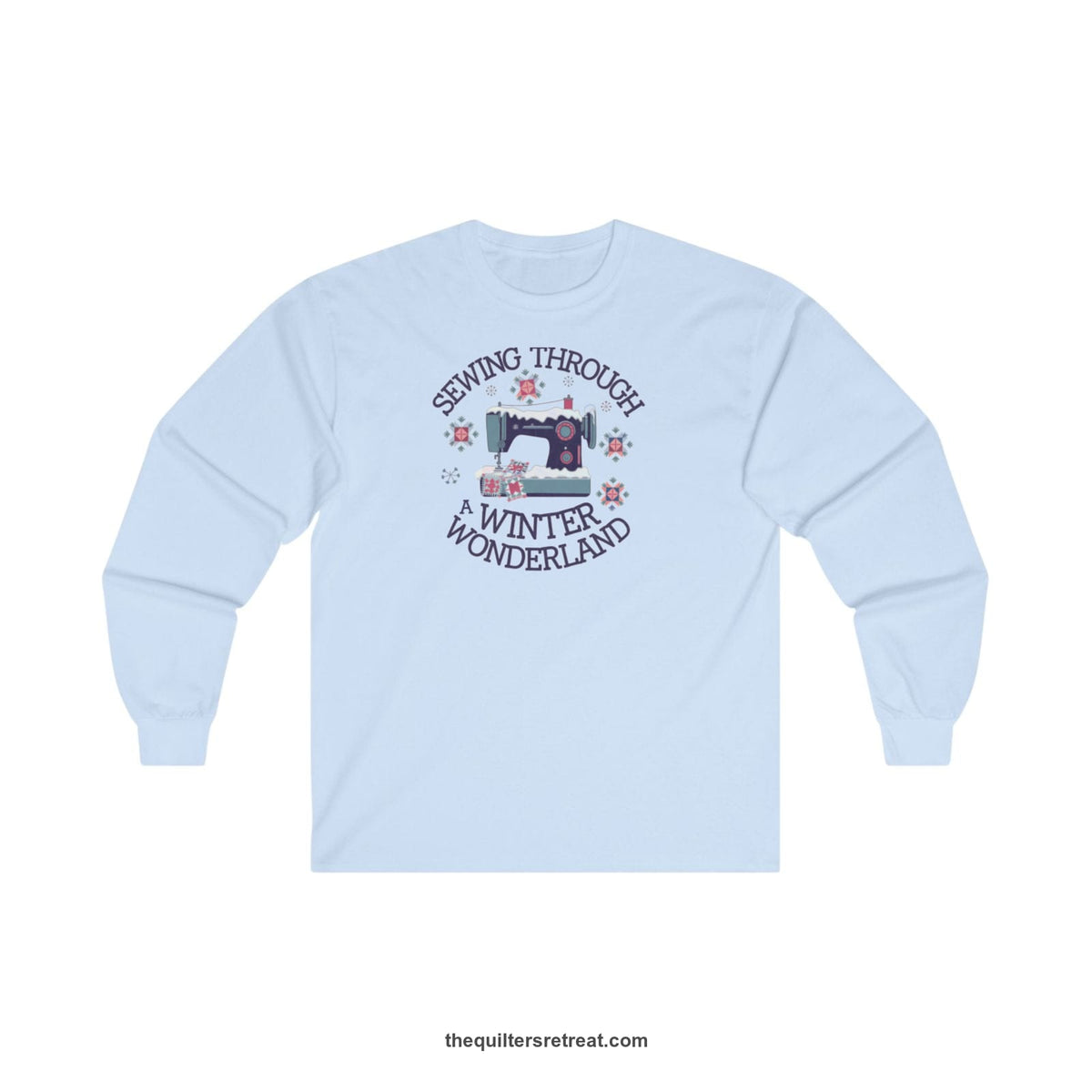 Quilter Gift: A Light Blue Long Sleeve T-Shirt with sewing machine covered in snow with festive quilting elements and 'Sewing Through a Winter Wonderland' text
