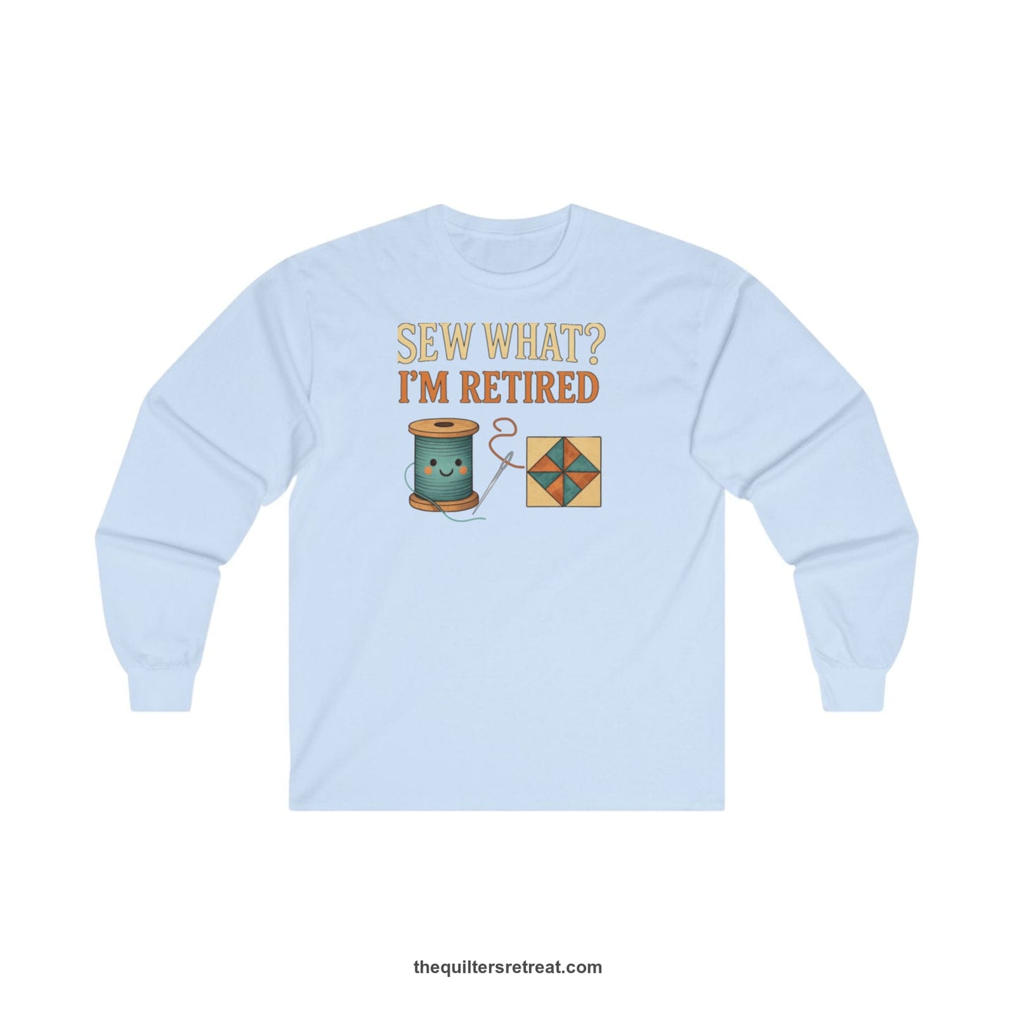 A Light Blue Long Sleeve T-Shirt with a funny "Sew What? I'm Retired" text with smiling spool and quilt block design