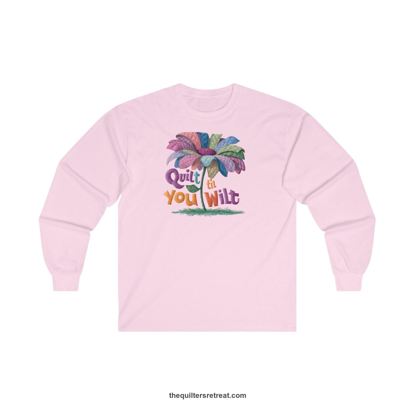 A Light Pink Long Sleeve T-Shirt with a whimsical quilted flower with bold "Quilt til You Wilt" text