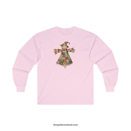 Quilter Gift: A Light Pink Long Sleeve T-Shirt with patchwork scarecrow with a cheerful face in a whimsical style