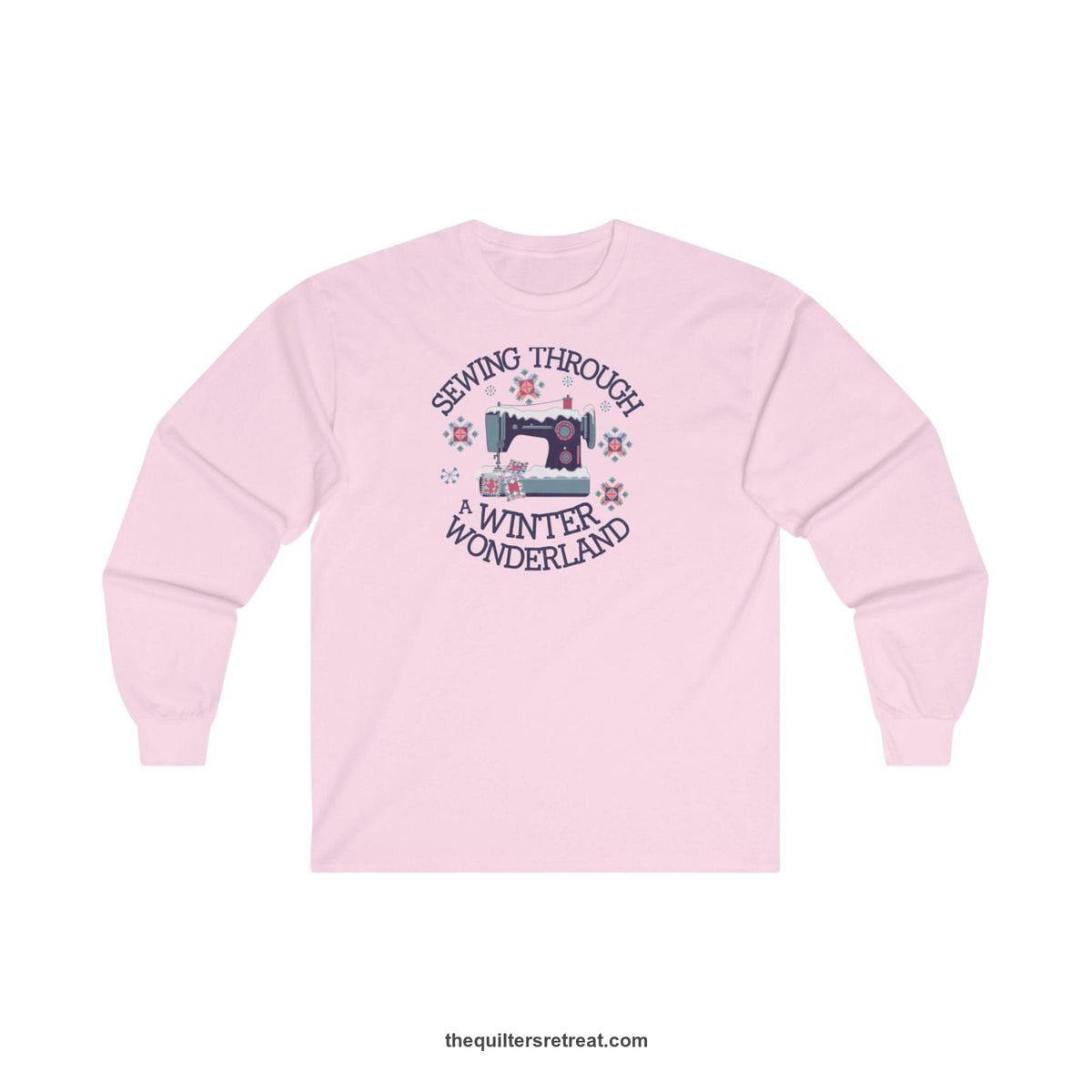 Quilter Gift: A Light Pink Long Sleeve T-Shirt with sewing machine covered in snow with festive quilting elements and 'Sewing Through a Winter Wonderland' text