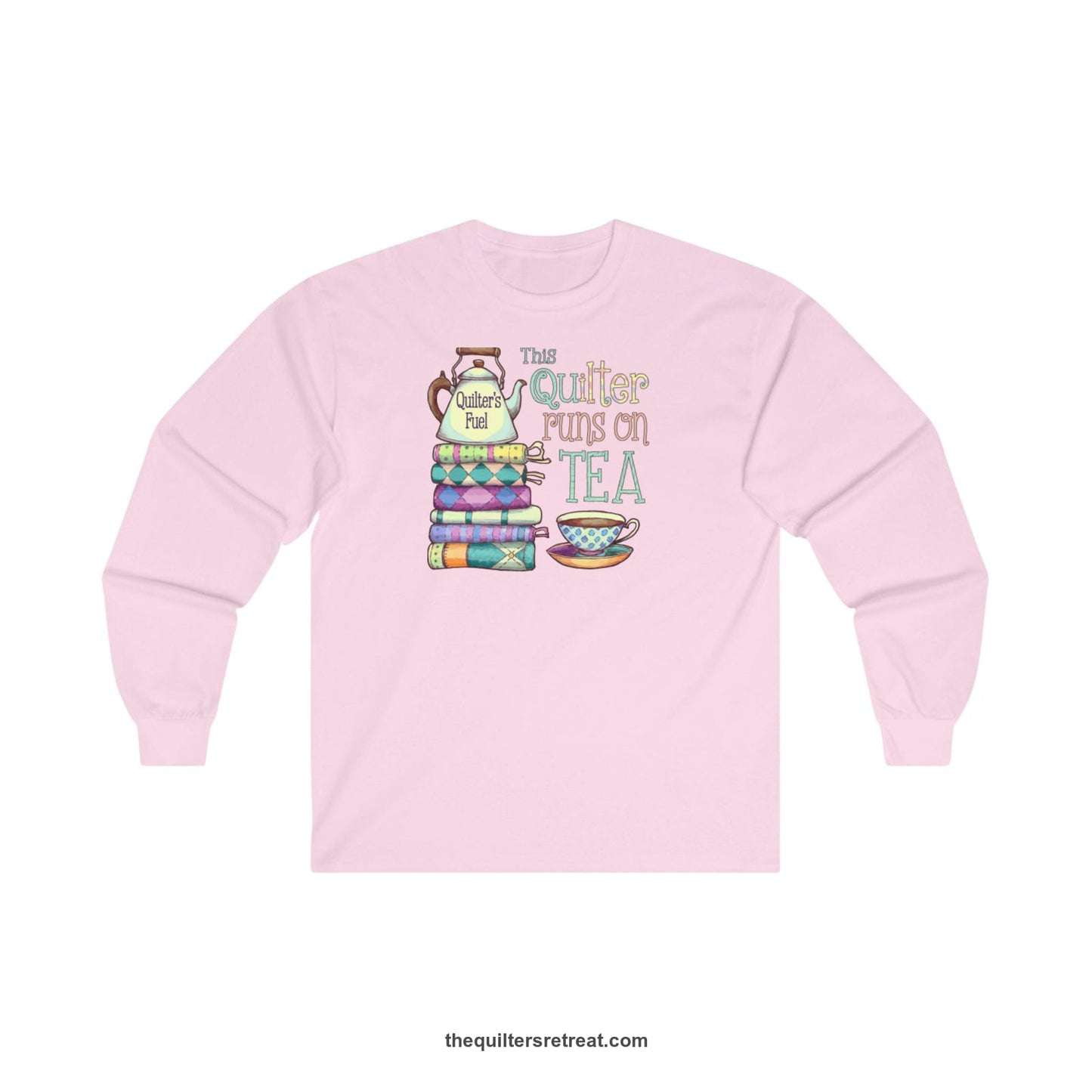 A Light Pink Long Sleeve T-Shirt with a stack of colorful quilts with teapot and cup, whimsical "This Quilter Runs on Tea" text