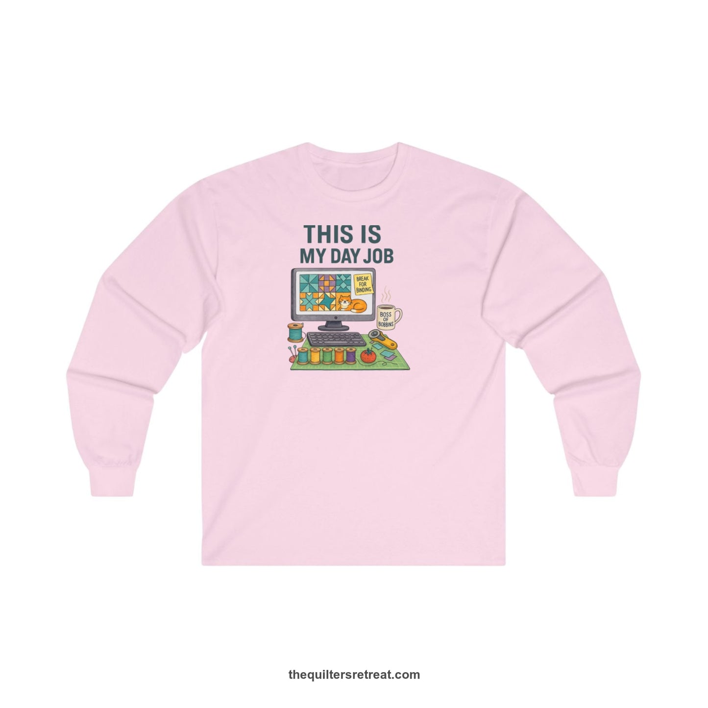 A Light Pink Long Sleeve T-Shirt with a computer quilt design, cat illustration, "THIS IS MY DAY JOB" text with sewing tools, playful style