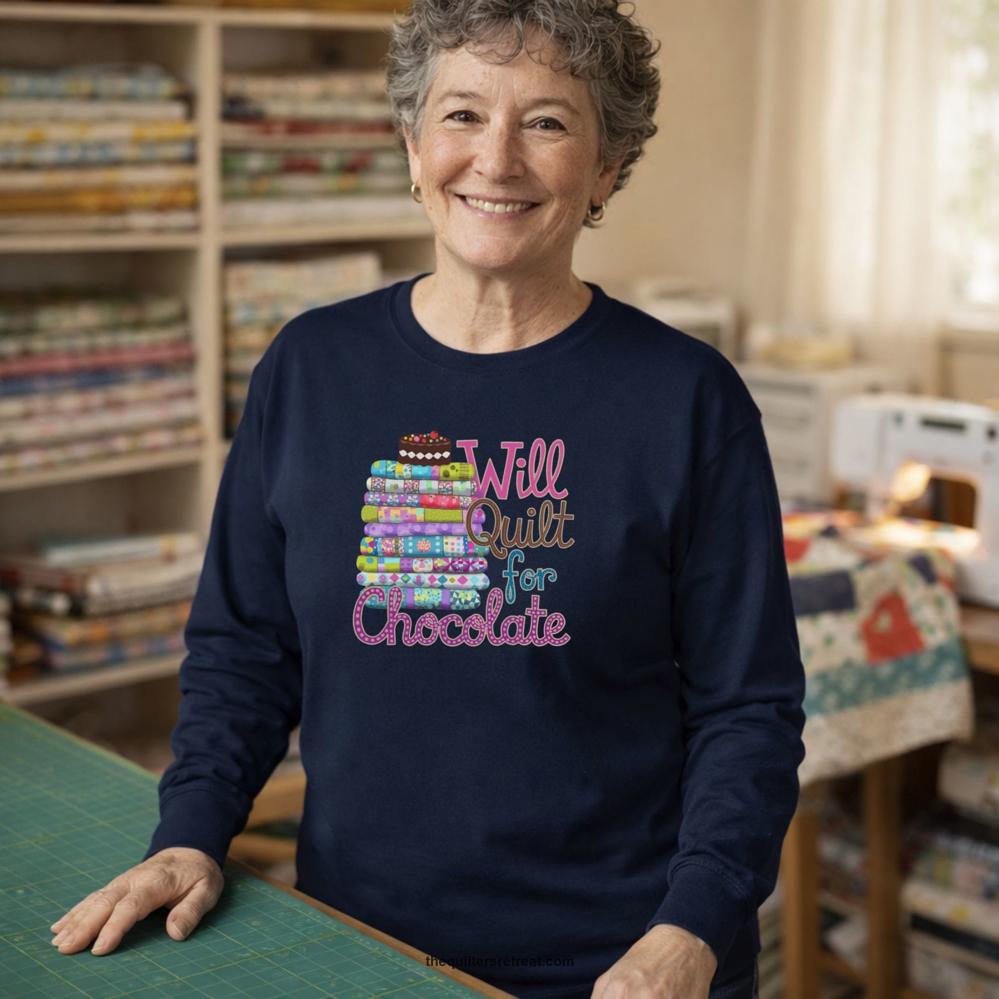 A Long Sleeve T-Shirt with a stack of colorful quilts topped with cake, whimsical "Will Quilt for Chocolate" text