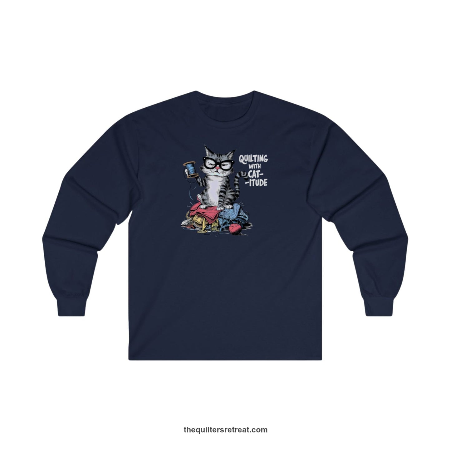A Navy Long Sleeve T-Shirt with a grumpy cat holding thread spool atop fabric pile with "Quilting with Cat-itude" text