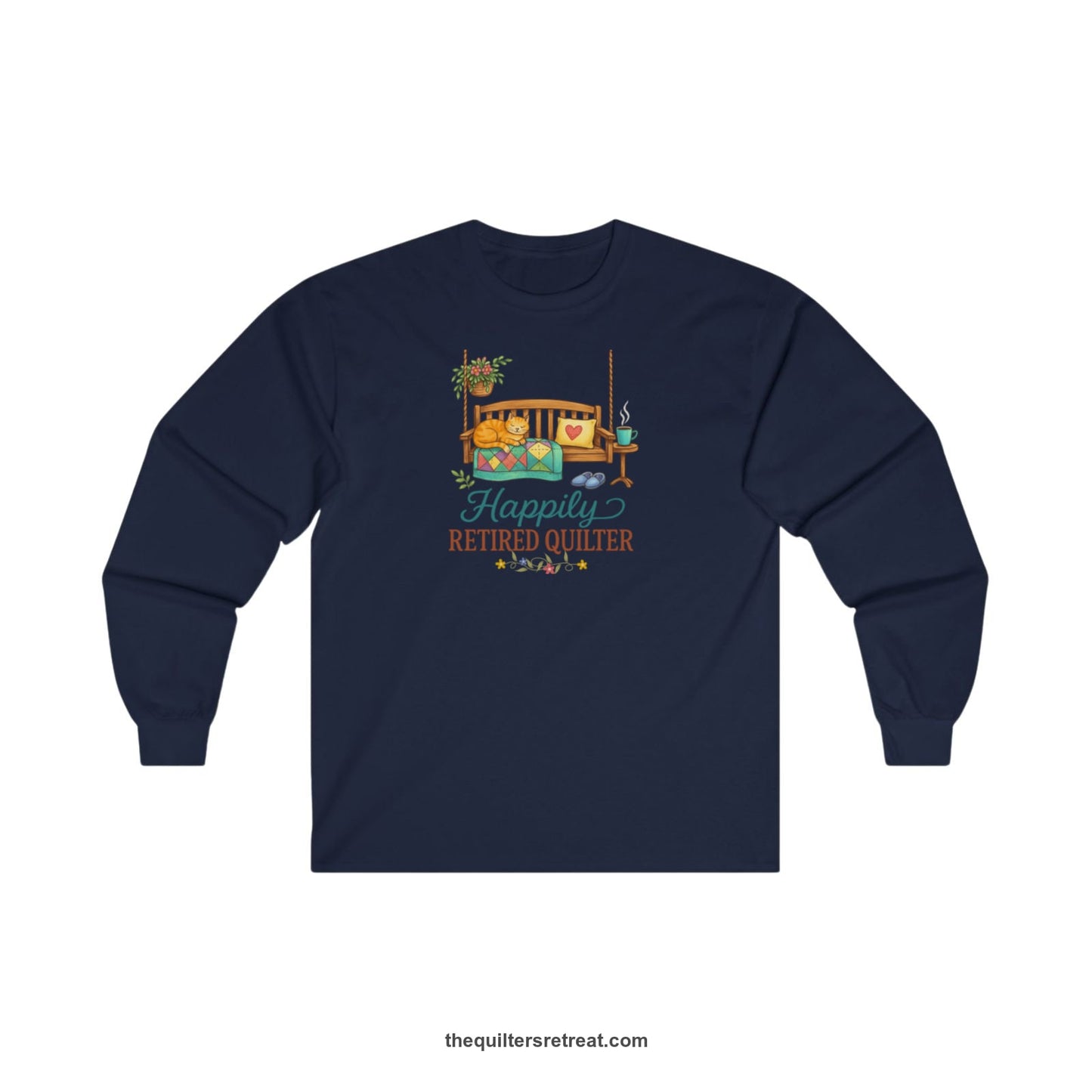A Navy Long Sleeve T-Shirt with a hanging bench with cozy cat and quilt, surrounded by plants, "Happily Retired Quilter" text