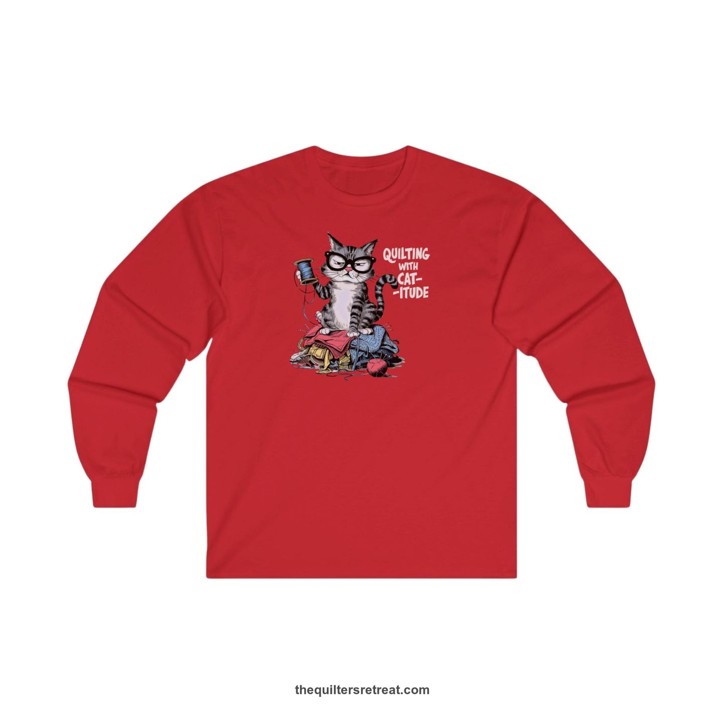 A Red Long Sleeve T-Shirt with a grumpy cat holding thread spool atop fabric pile with "Quilting with Cat-itude" text