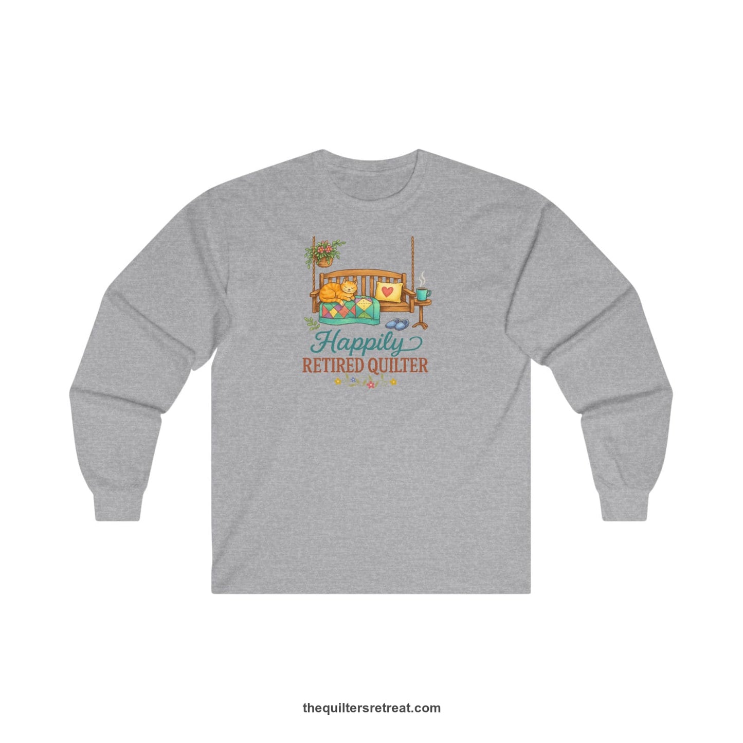 A Sport Grey Long Sleeve T-Shirt with a hanging bench with cozy cat and quilt, surrounded by plants, "Happily Retired Quilter" text