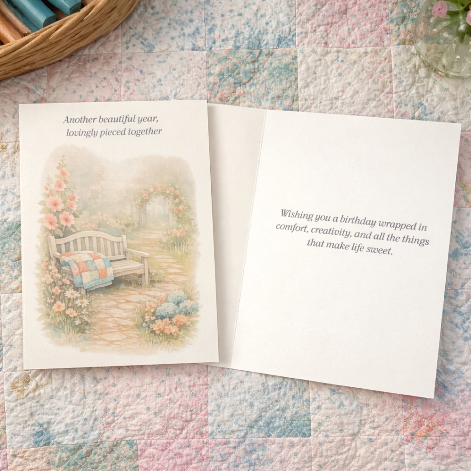 Soft birthday card for quilters featuring a garden bench, quilt, and cottage flowers.