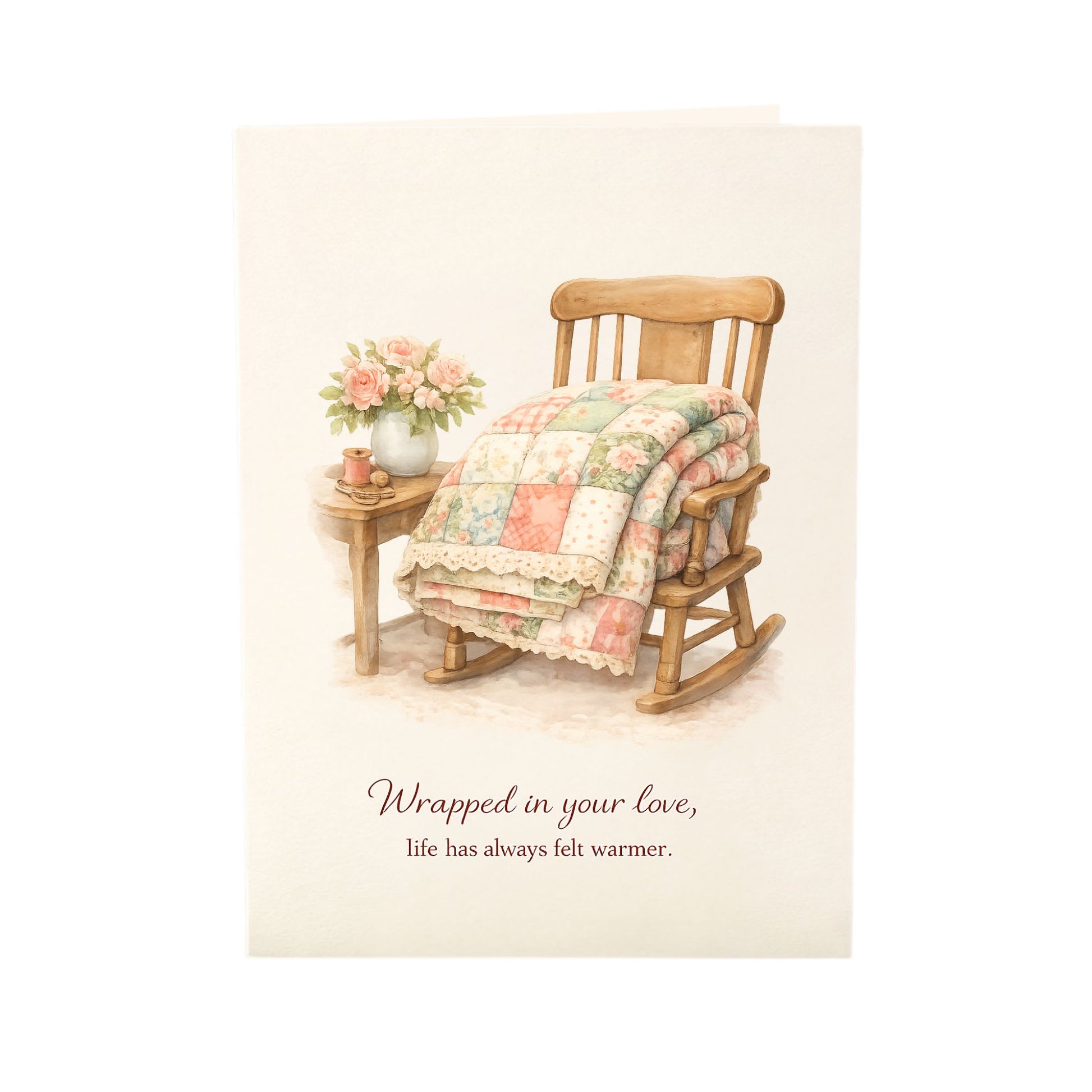 Quilter Gift: A Mother's Day Card - Soft with Wooden rocking chair with quilt and flowers, cozy vintage feel, "Wrapped in your love" text.