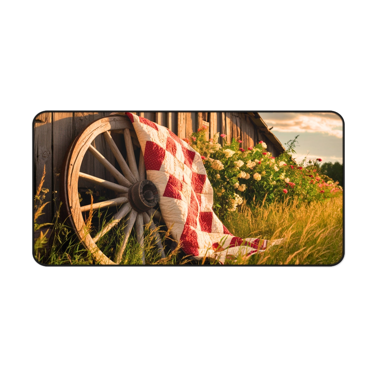Red and white checkerboard quilt draped over an old wooden wagon wheel. Colorful flowers and golden grass surround the scene, with a rustic barn in the background. Perfect gift for quilters.