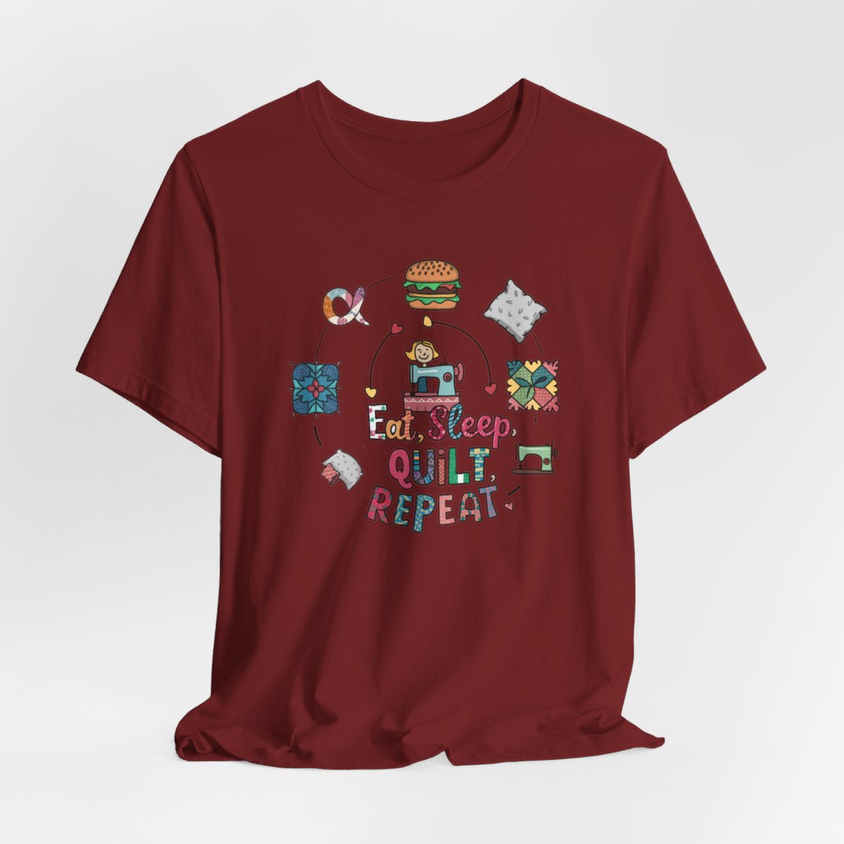 A Cardinal funny quilting T-Shirt with the phrase Eat, Sleep, Quilt, Repeat  showing the cycle of a quilter's day with eating, sleeping, and quilting