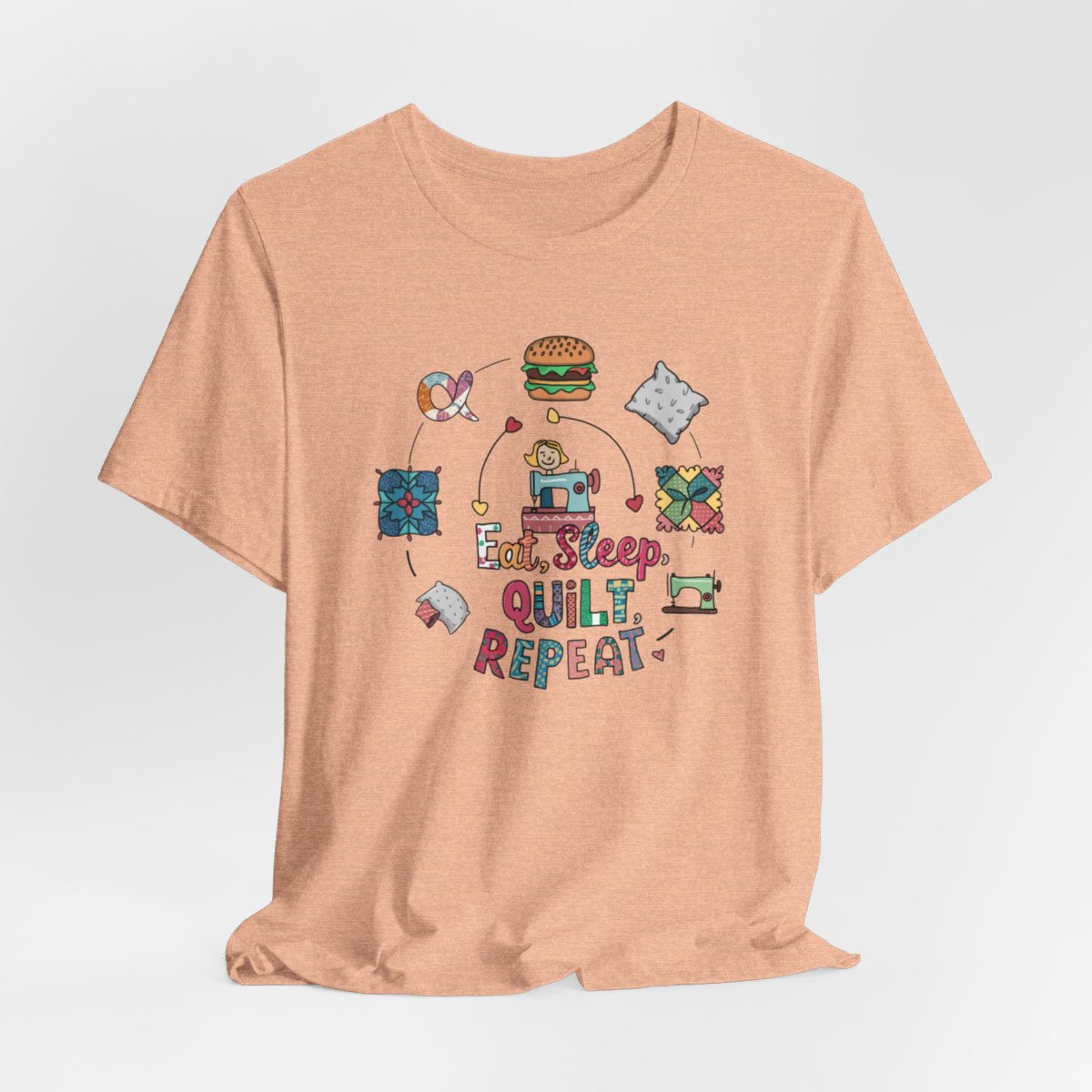A Heather Peach funny quilting T-Shirt with the phrase Eat, Sleep, Quilt, Repeat  showing the cycle of a quilter's day with eating, sleeping, and quilting