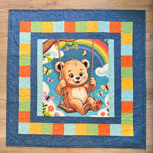 Rainbow bear baby quilt panel sewn into a finished baby quilt