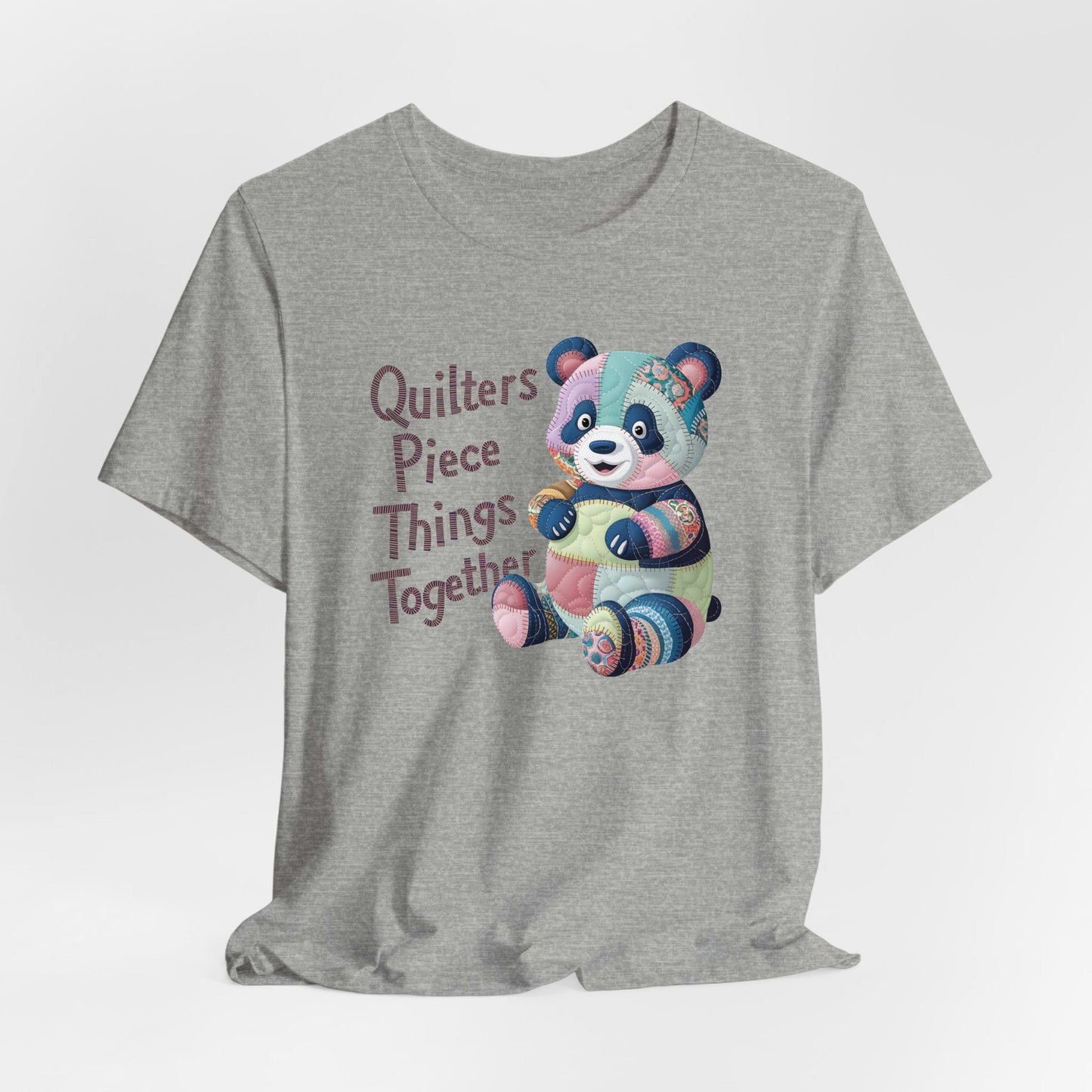 A Athletic Heather Short Sleeve T-Shirt with a patchwork panda with "Quilters Piece Things Together" text in a whimsical style