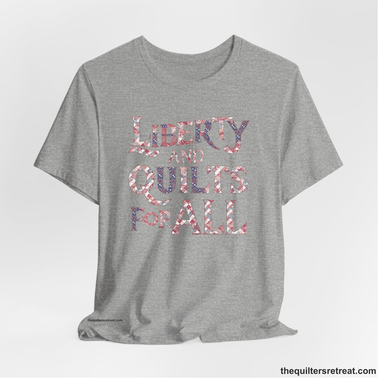 A Athletic Heather Short Sleeve T-Shirt with a Liberty and Quilts for All" text with patchwork quilt pattern in a vintage style