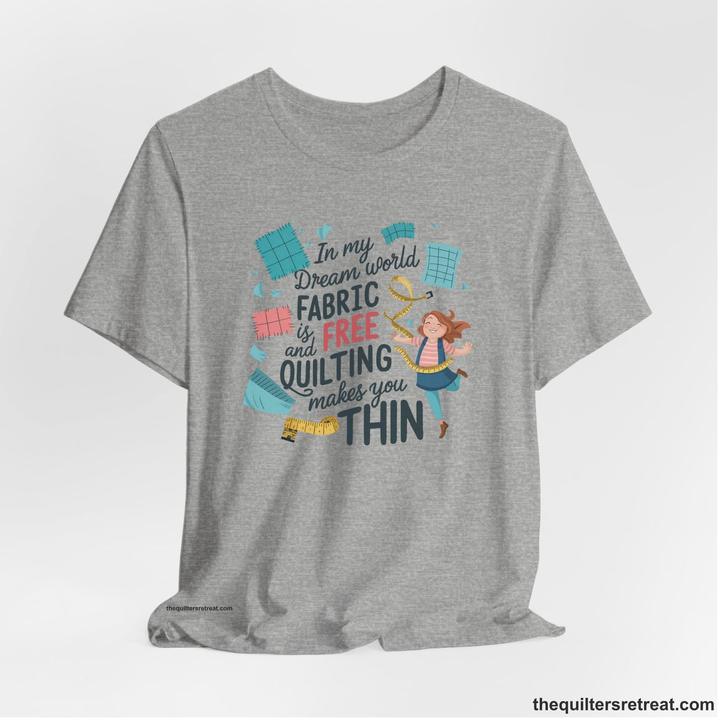 A Athletic Heather Short Sleeve T-Shirt with a inspirational quilting text with playful seamstress and colorful fabric scraps in whimsical style