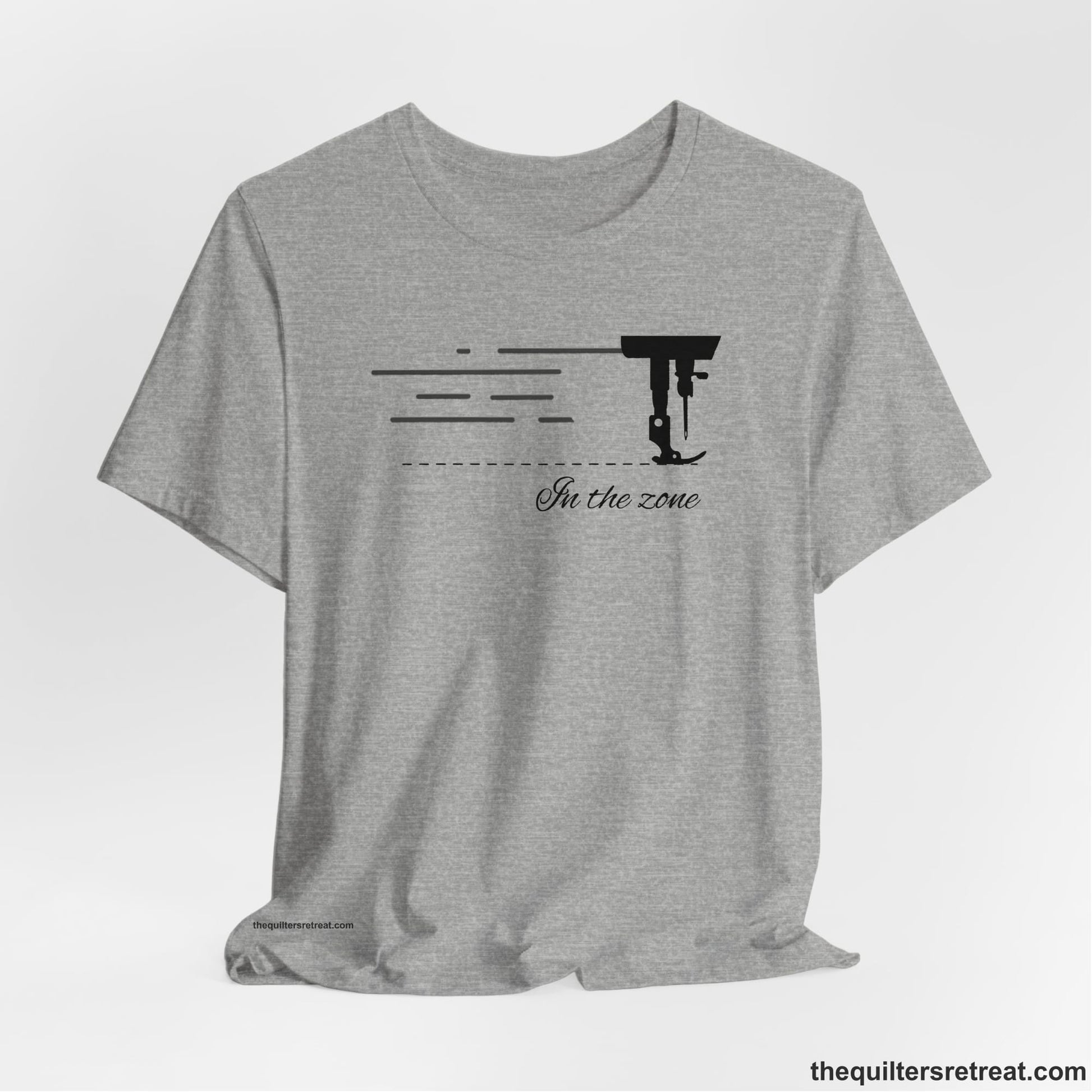 A Athletic Heather Short Sleeve T-Shirt with a vintage sewing machine illustration with floral accents and "Sewing Mends the Soul" text