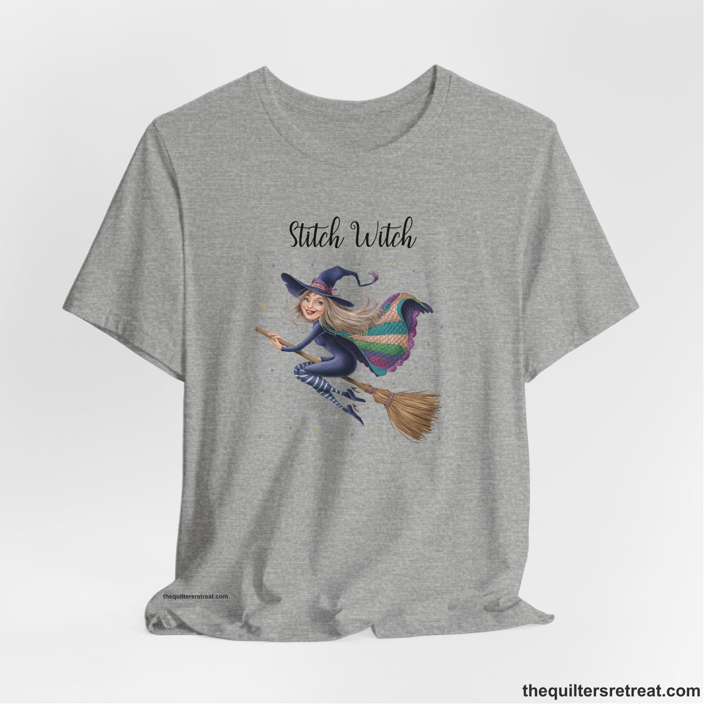 A Athletic Heather Short Sleeve T-Shirt with a playful witch on broomstick with patchwork cape and starry background in a whimsical style