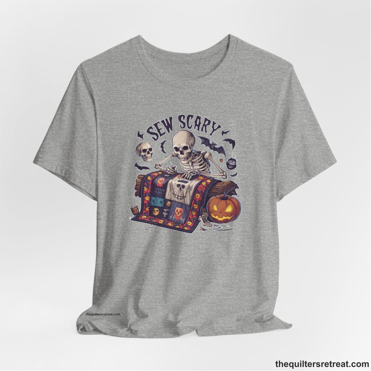 A Athletic Heather Short Sleeve T-Shirt with a skeleton quilting with spooky accents and "Sew Scary" text in a Halloween theme