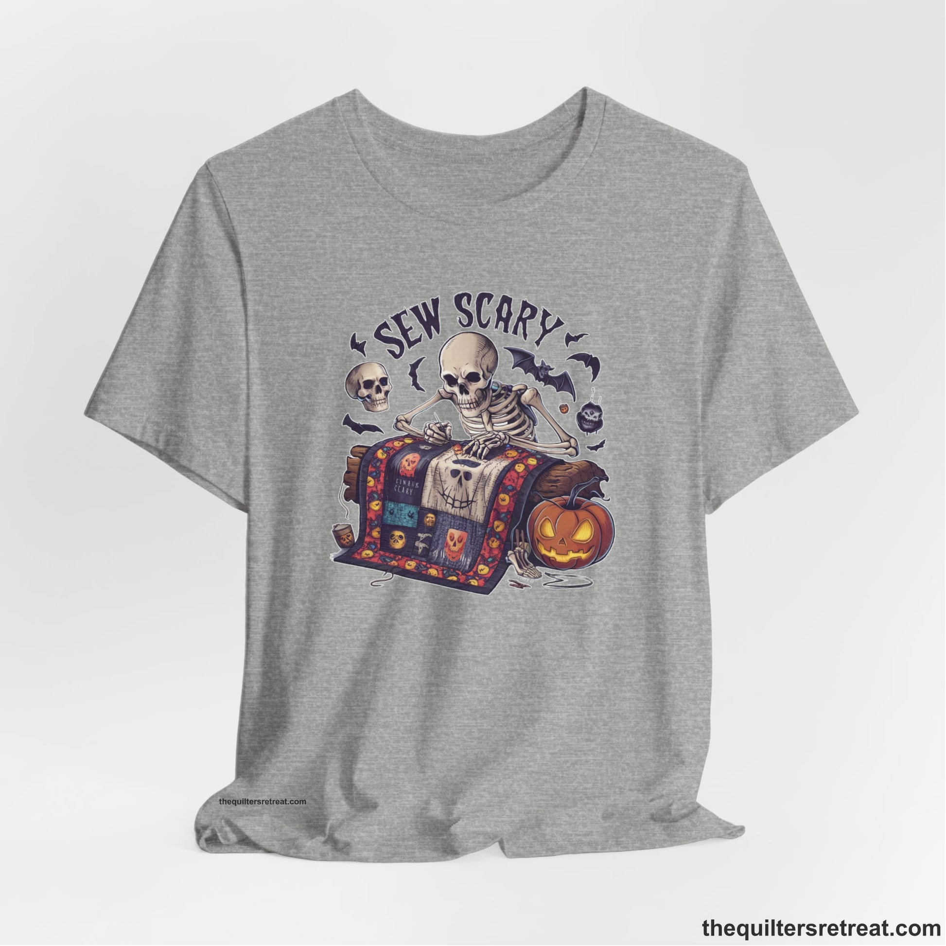 A Athletic Heather Short Sleeve T-Shirt with a skeleton quilting with spooky accents and "Sew Scary" text in a Halloween theme
