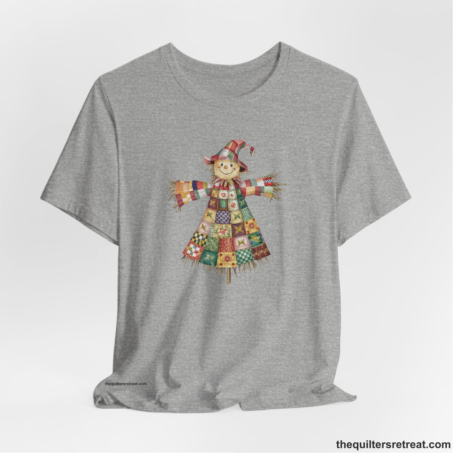 A Athletic Heather Short Sleeve T-Shirt with a patchwork scarecrow with a cheerful face in a whimsical style