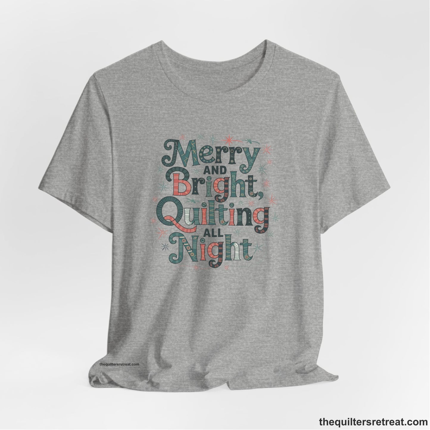 A Athletic Heather Short Sleeve T-Shirt with a Merry and Bright Quilting All Night text with festive patterns and stars in a whimsical style