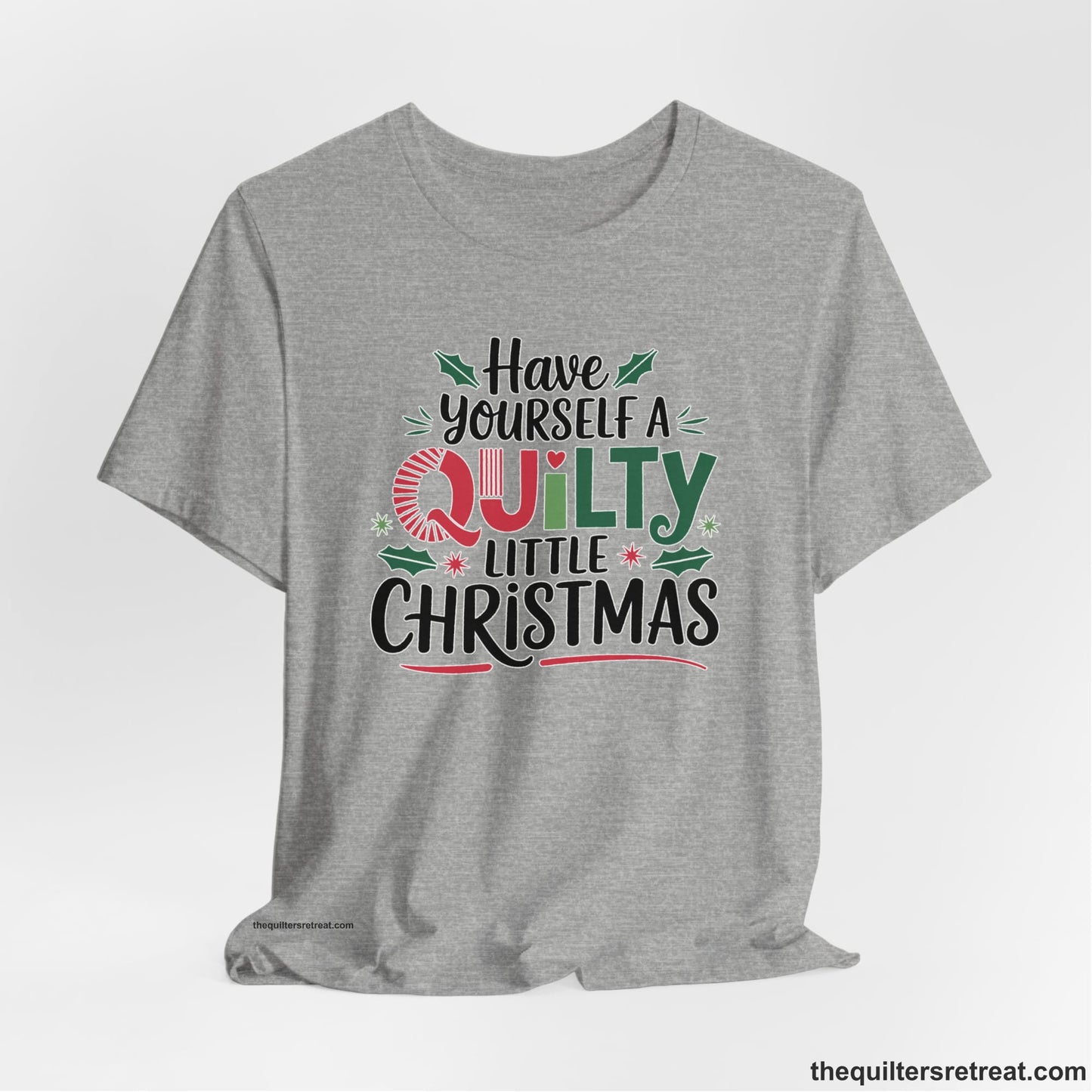A Athletic Heather Short Sleeve T-Shirt with a festive "Have Yourself a Quilty Little Christmas" text with holly and quilt patterns