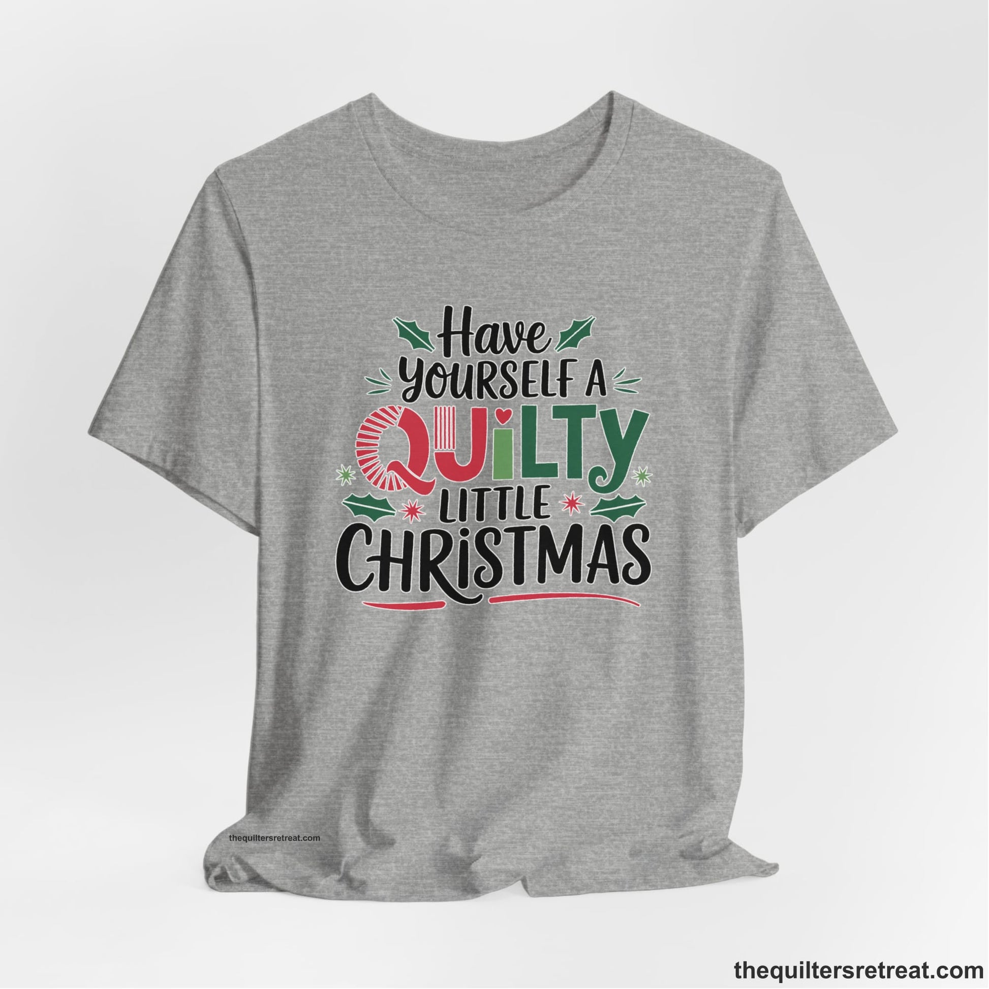 A Athletic Heather Short Sleeve T-Shirt with a festive "Have Yourself a Quilty Little Christmas" text with holly and quilt patterns