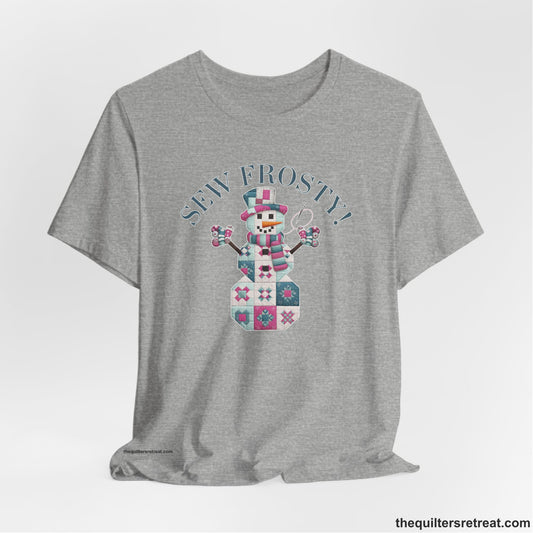 A Athletic Heather Short Sleeve T-Shirt with a snowman quilt pattern with "Sew Frosty!" text in a crafty style
