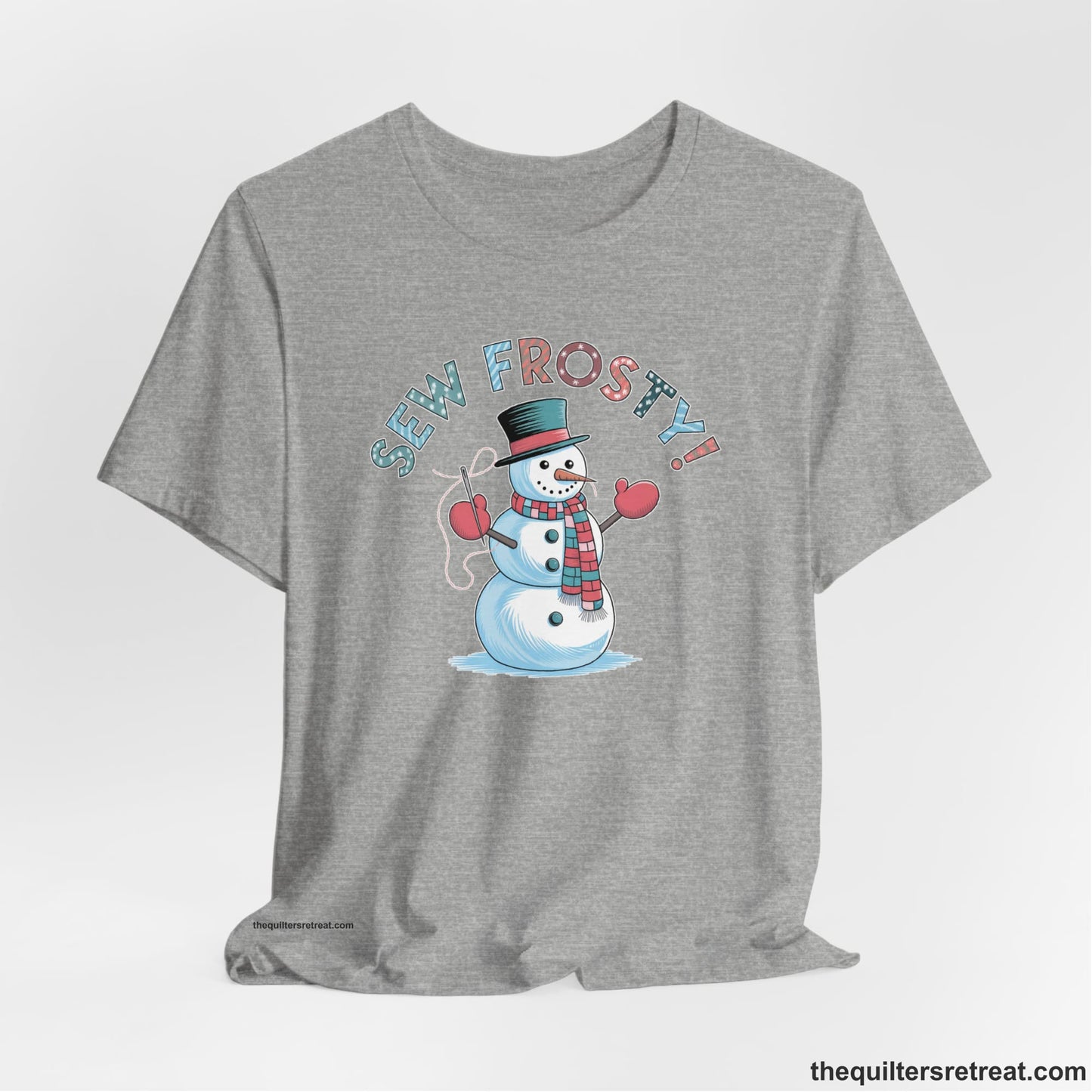 A Athletic Heather Short Sleeve T-Shirt with a playful snowman sewing illustration with "Sew Frosty!" text in a festive style