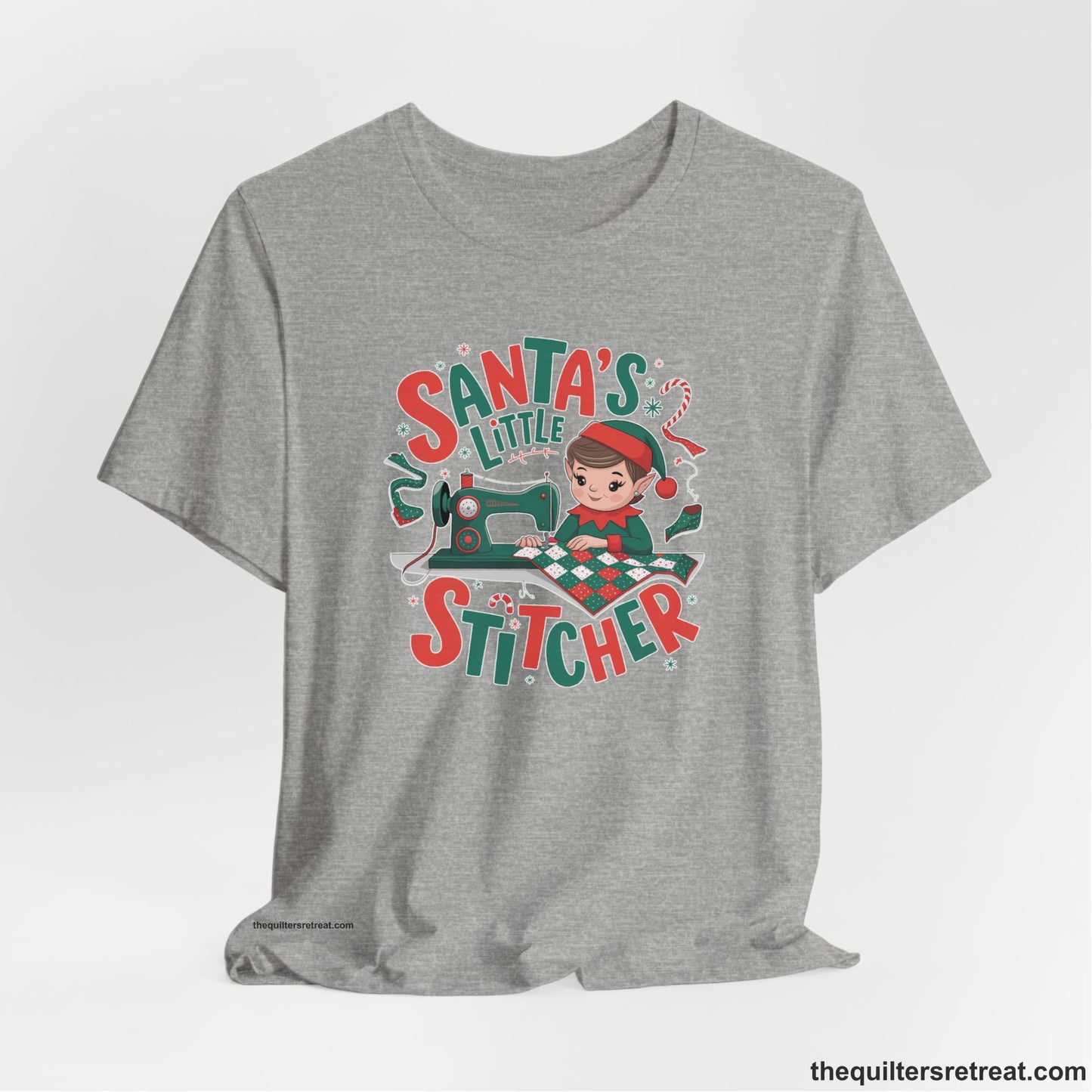 A Athletic Heather Short Sleeve T-Shirt with a santa's little stitcher elf sewing quilt with festive colors in playful style