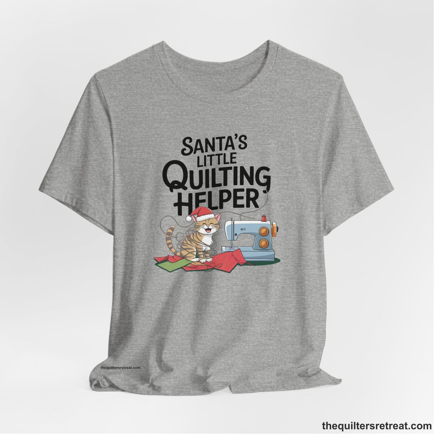 A Athletic Heather Short Sleeve T-Shirt with a santa-hat-wearing kitten with a sewing machine and "Santa's Little Quilting Helper" text in playful style